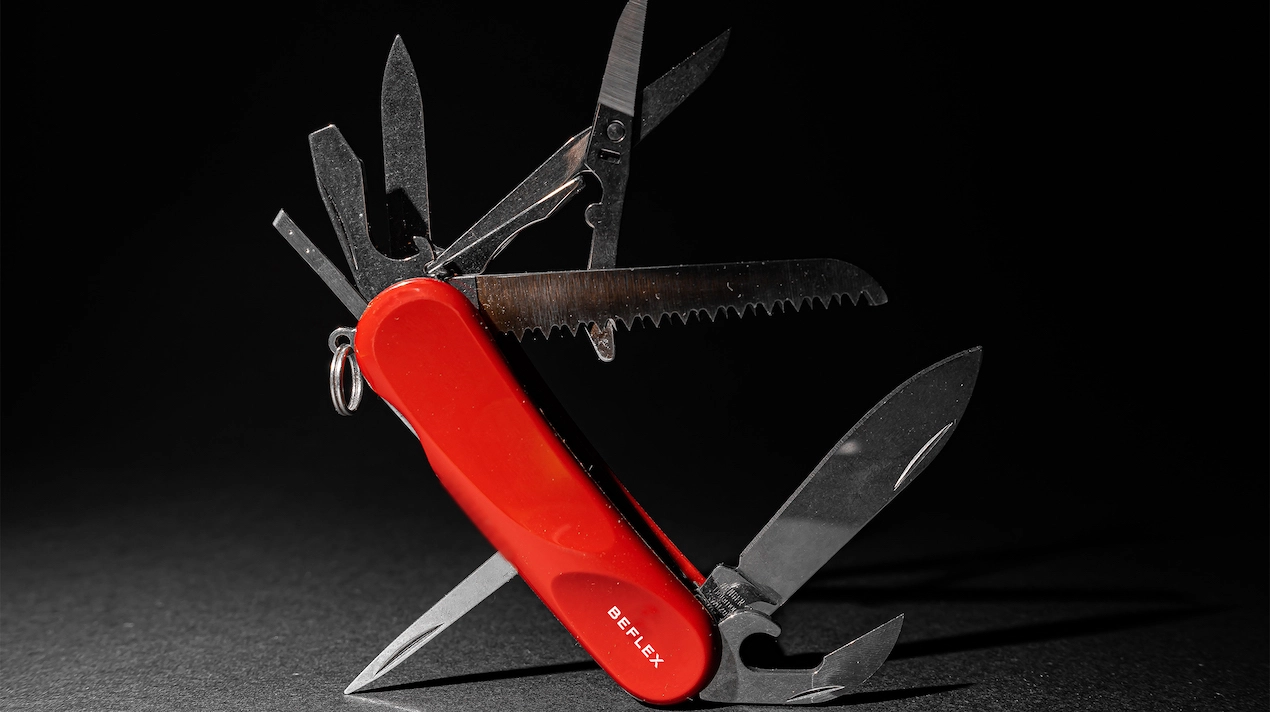 open red swiss knife with beflex logo featuring multiple tools for various purposes symbolizing versatility