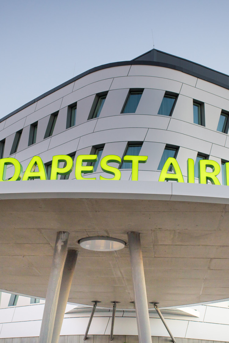 green illuminated channel letter signage on a roof displaying ibis styles budapest airport hotel