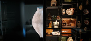 an exhibition of ceramic vessels on glass shelves