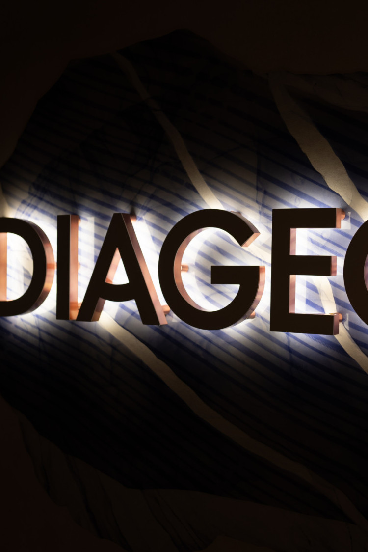 striking diageo signage with highly visible backlighting against a dark background