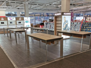 unique huawei shop in shop solution with tables, accesories cabinets, and lightb...