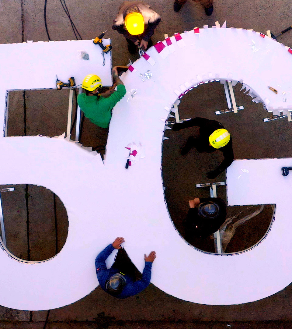 aerial view capturing the Telekom 5G channel letter signage surrounded by people